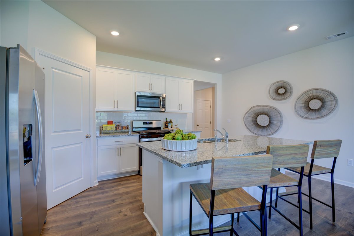 kitchen with white cabinetry, large island, and stainless steel appliances