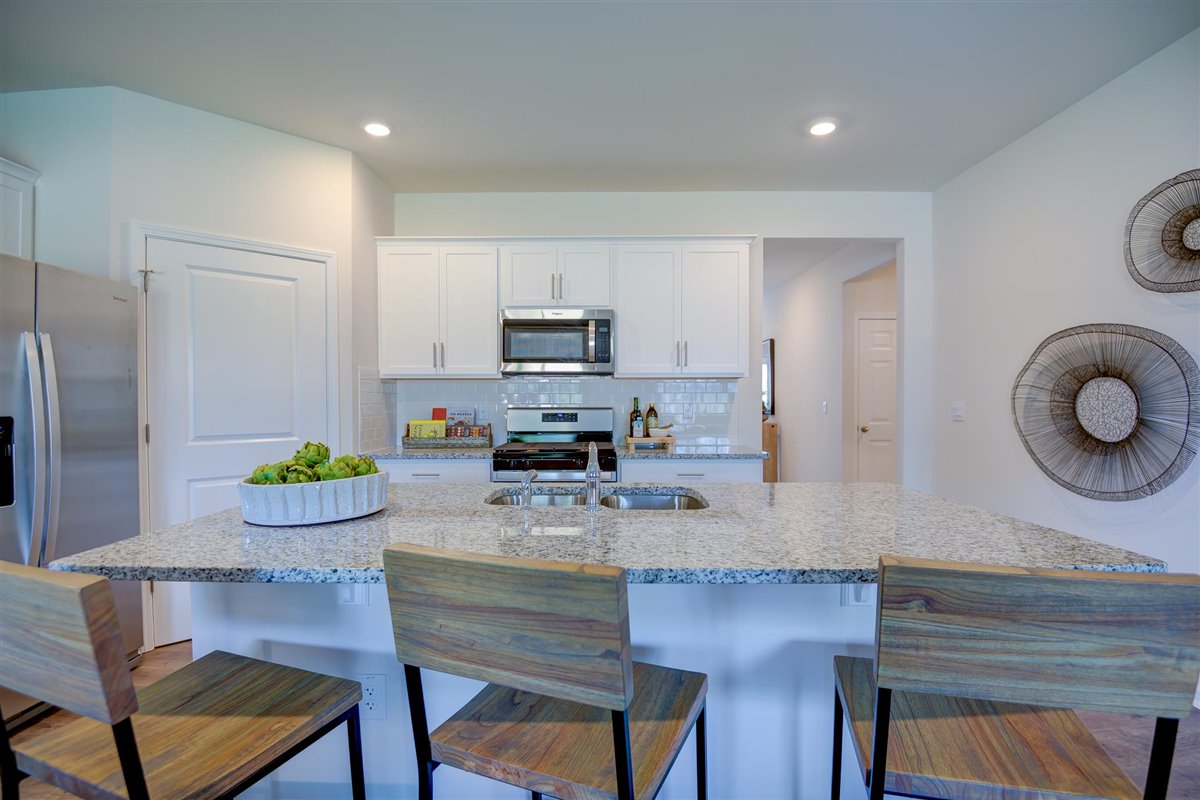 kitchen with white cabinetry, large island, and stainless steel appliances