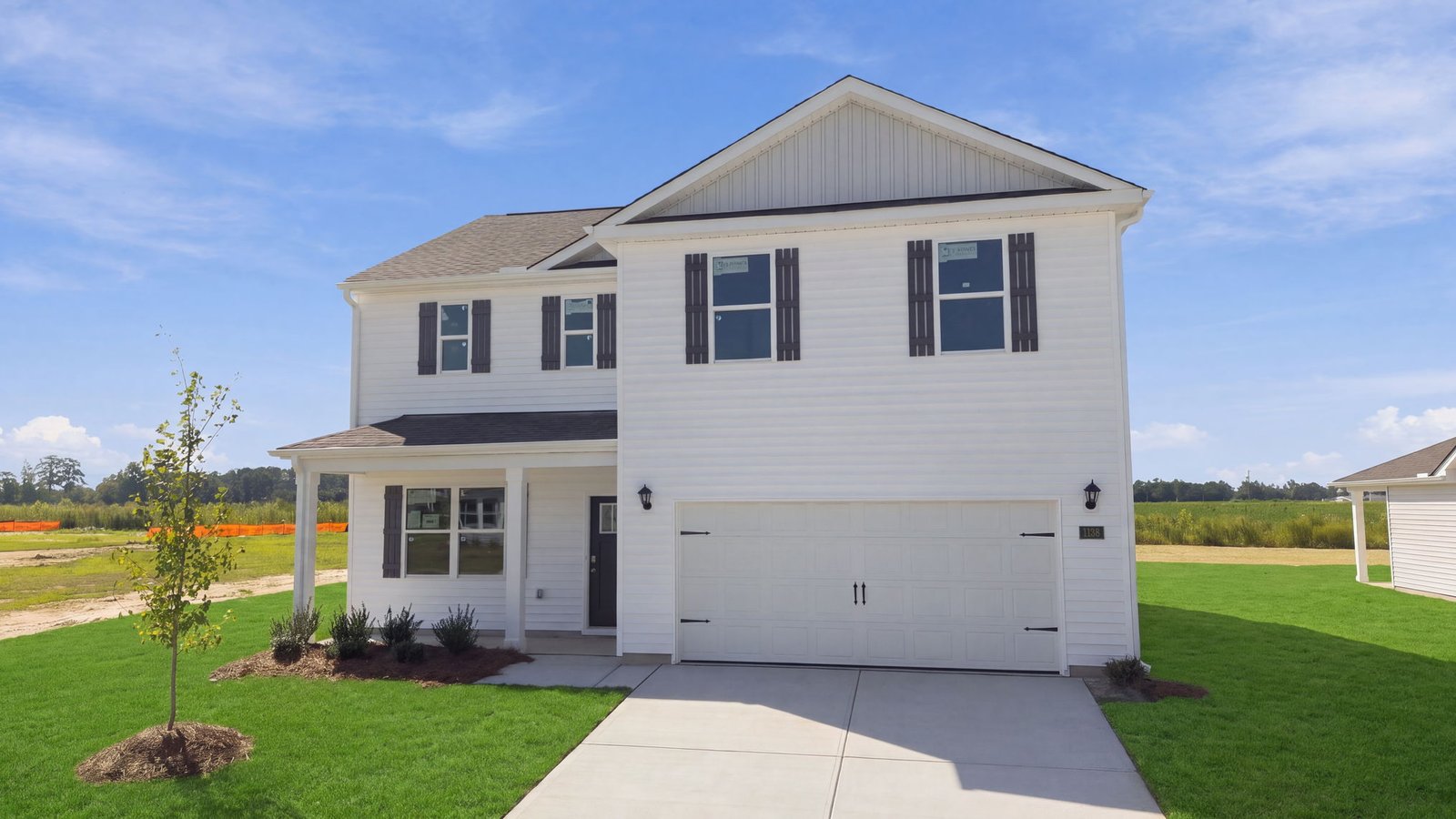 two story white home with two car garage