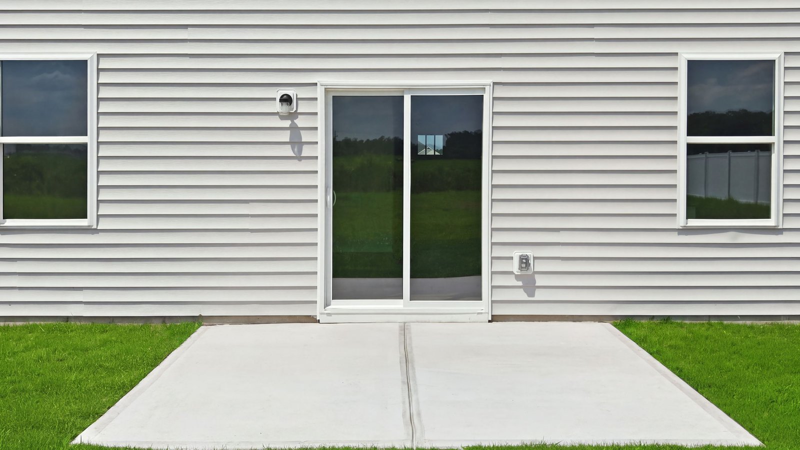 rear view of the home and back patio pad