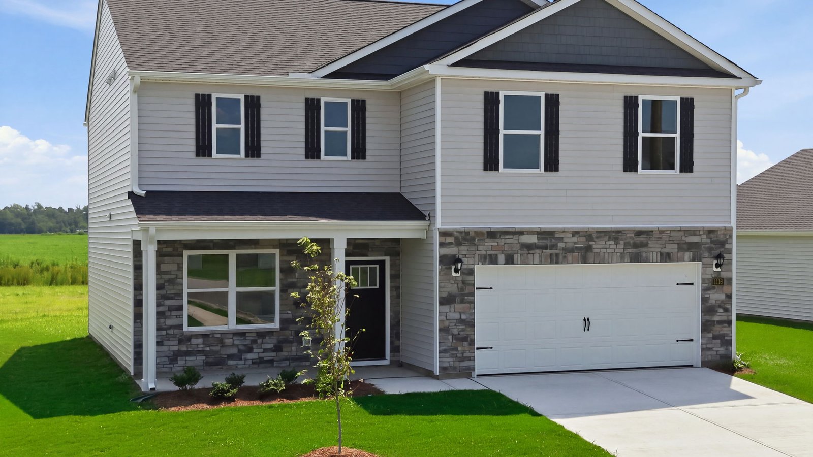 exterior of home with vinyl and brick with two car garage