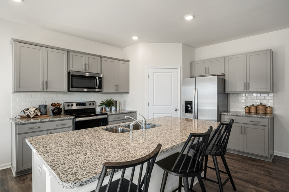 kitchen with light grey cabinetry, large island and stainless steel appliances