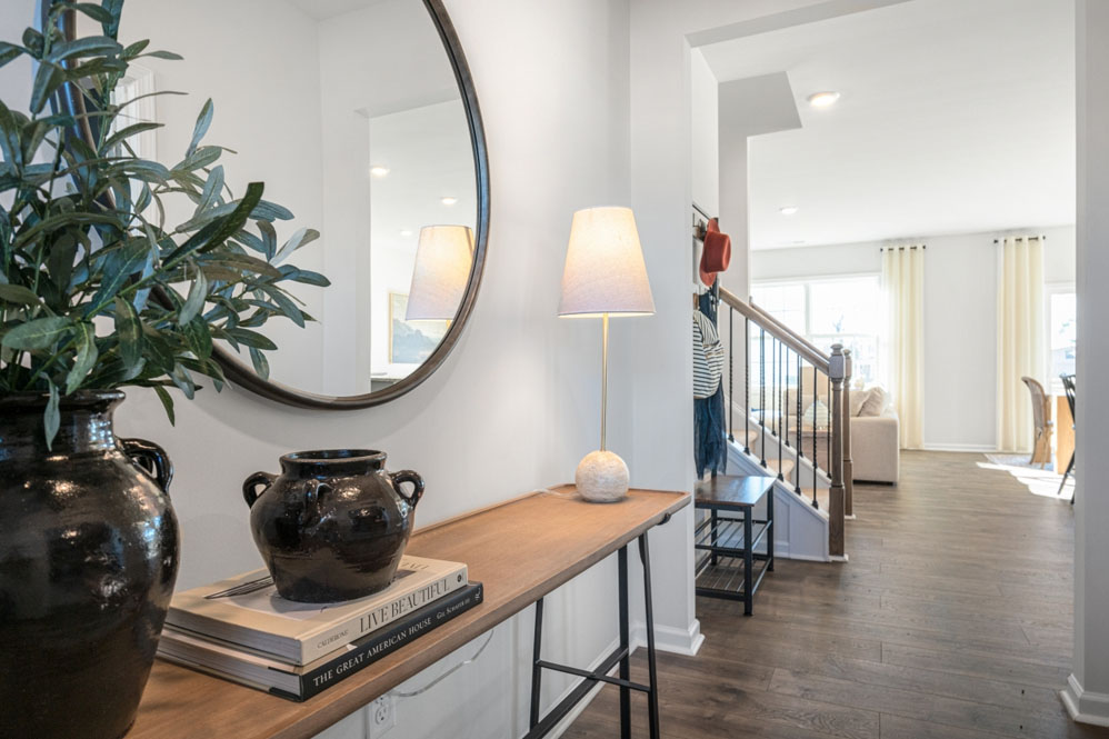 front entry way of home featuring brown flooring and white walls