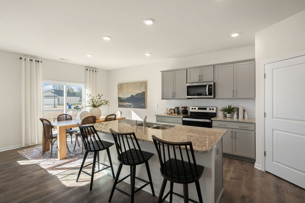 kitchen with light grey cabinetry, large island and stainless steel appliances