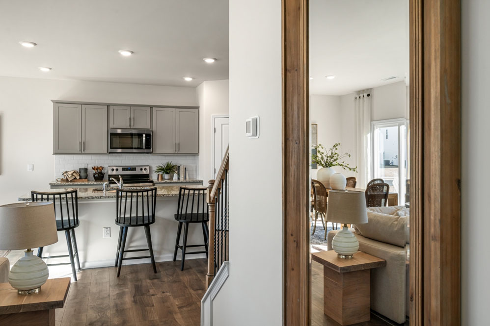 kitchen with light grey cabinetry, large island and stainless steel appliances
