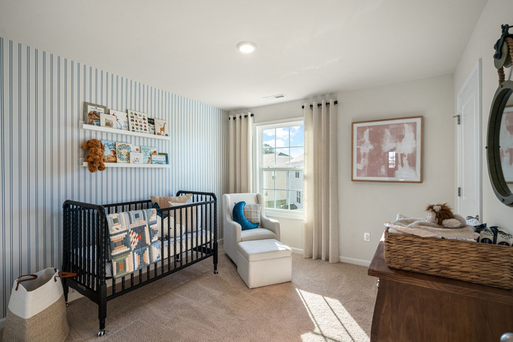 bedroom with beige carpet, white walls and a window