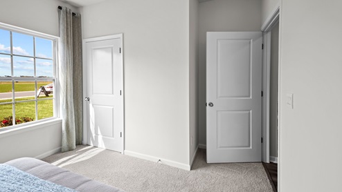 Bedroom with carpet flooring and a large window for natural light