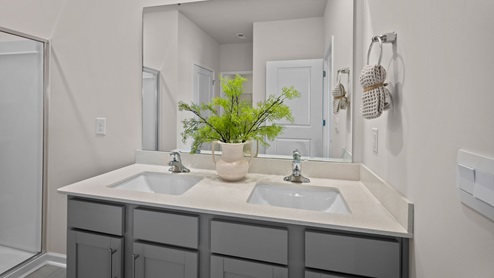 Primary bathroom with quartz countertops and a walk in shower