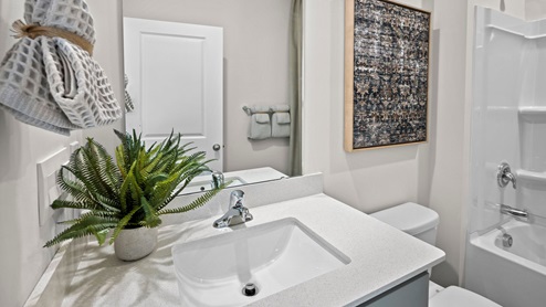 Bathroom with quartz countertop and a bathtub