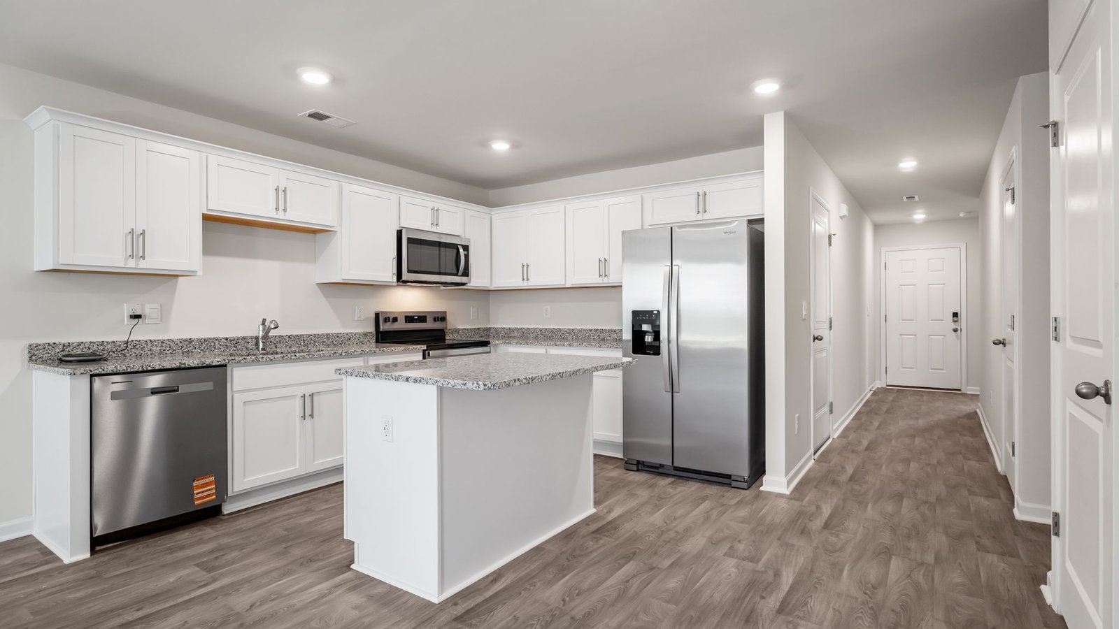large kitchen with peninsula and white cabinets