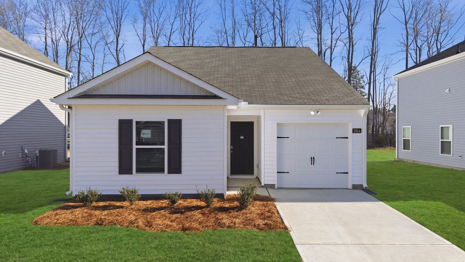 Exterior of the home with white vinyl and one car garage