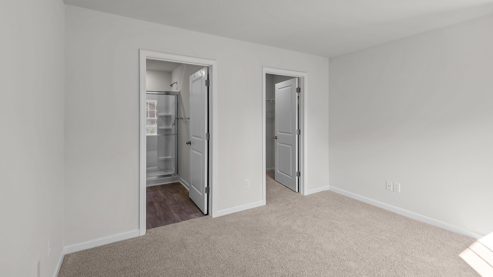 Primary bedroom with carpet flooring