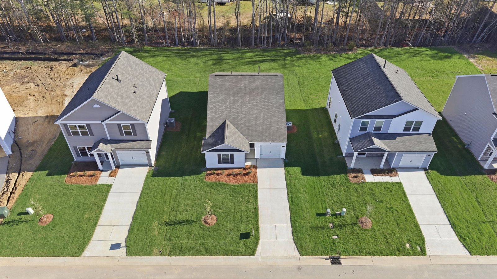 Aerial photo of the one story home in the neighborhood and yard