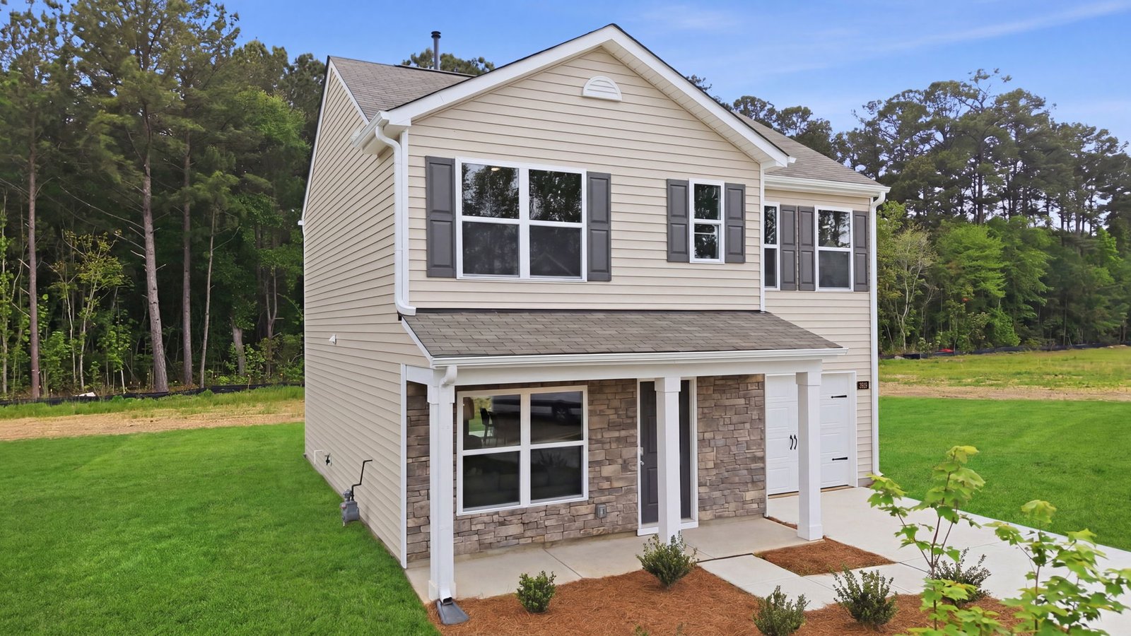 front of the two story home with brick and vinyl