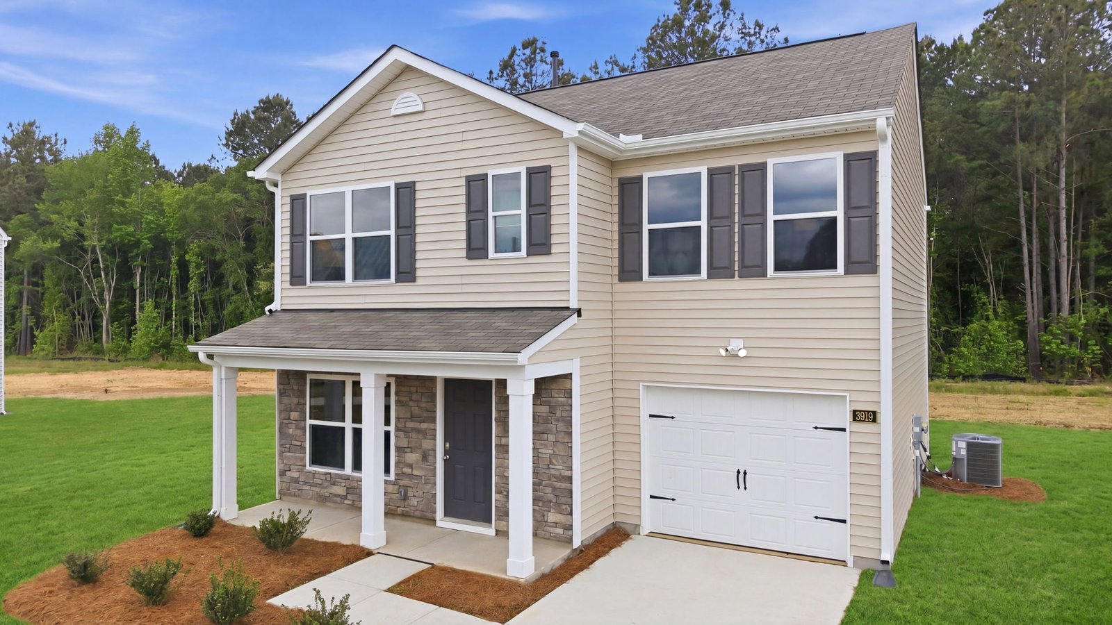 front view of two story home with brick and vinyl and attached garage
