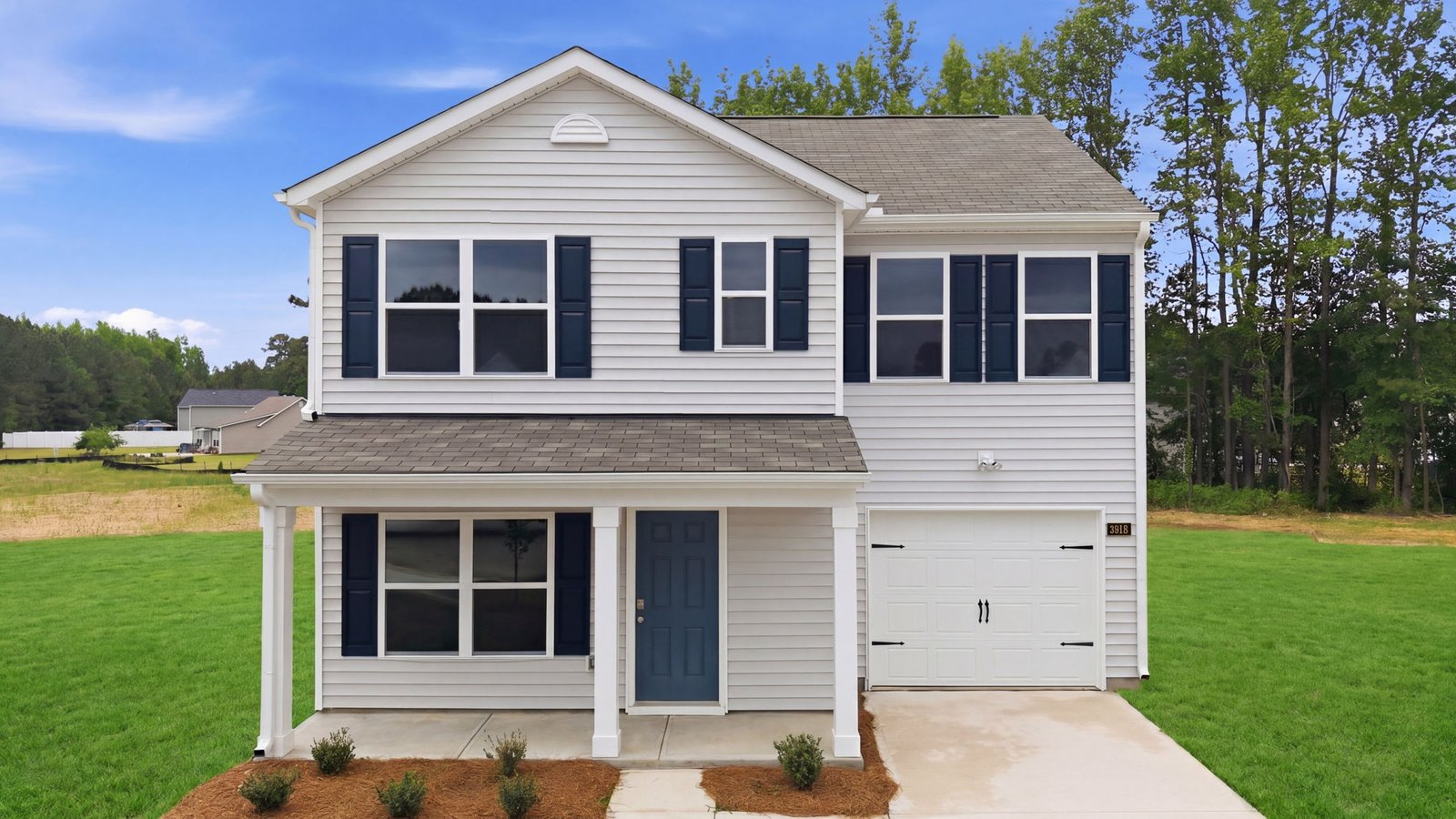 exterior of two story home with white vinyl and blue shutters