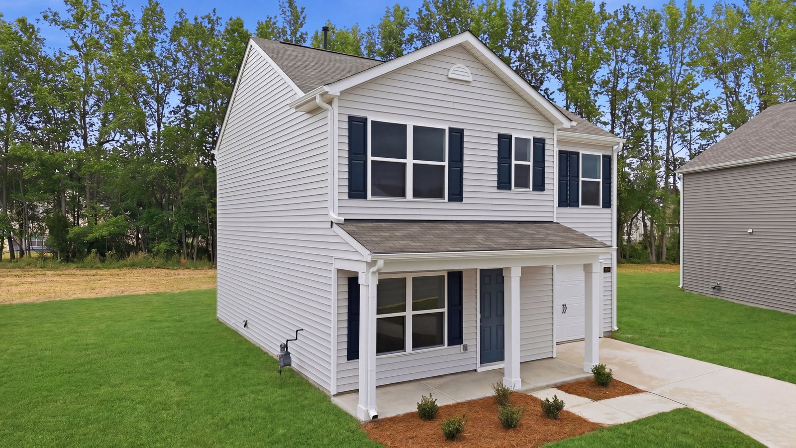 two story home with two car garage and covered front porch