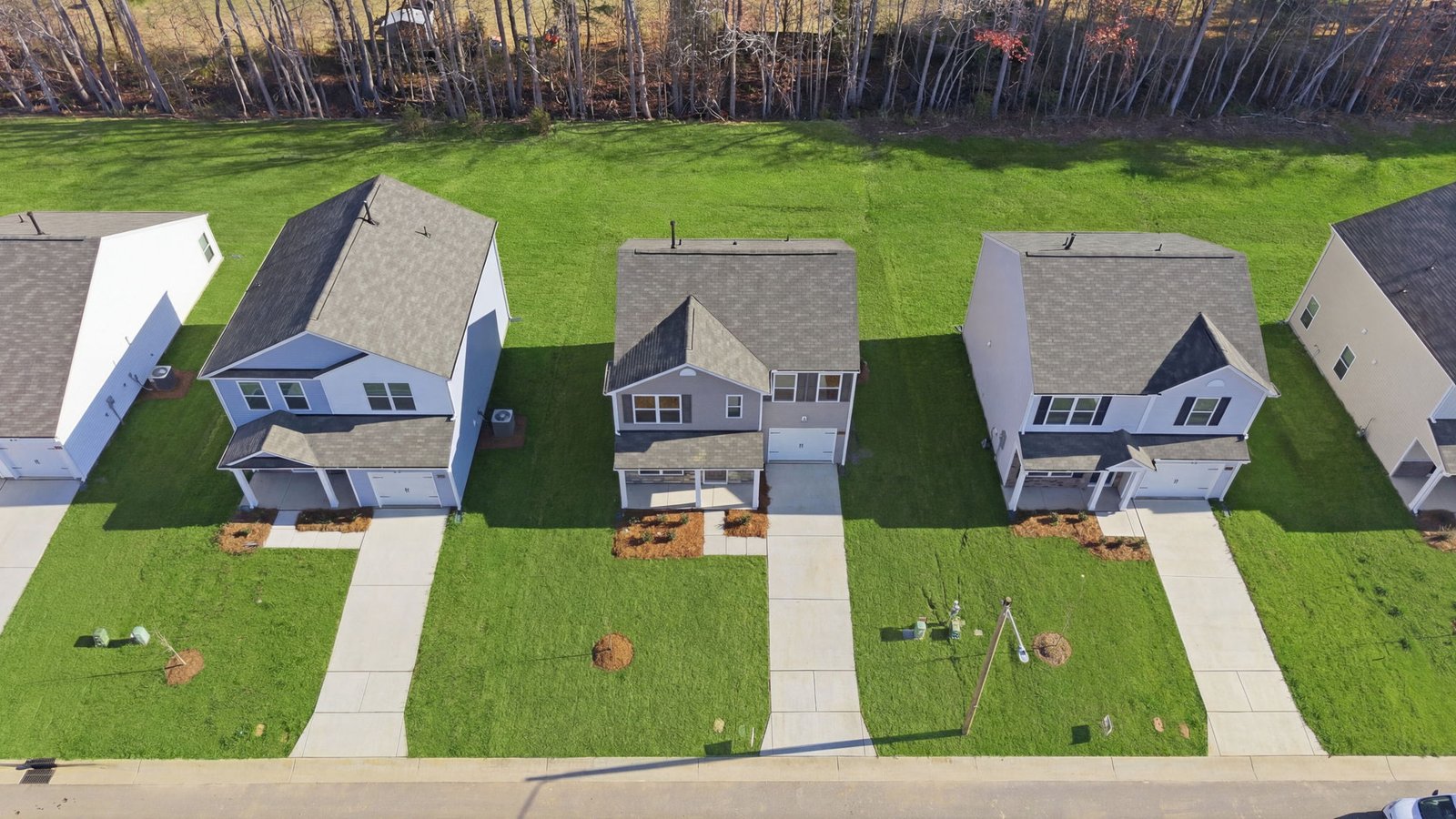 Aerial photo from above of view of the home and driveway and backyard