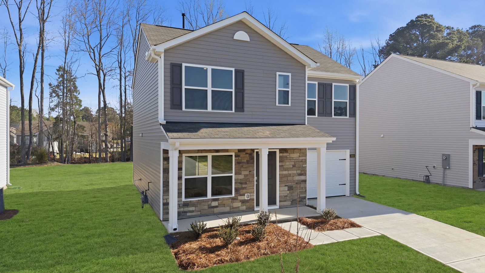 Two story home with covered front porch and two car garage