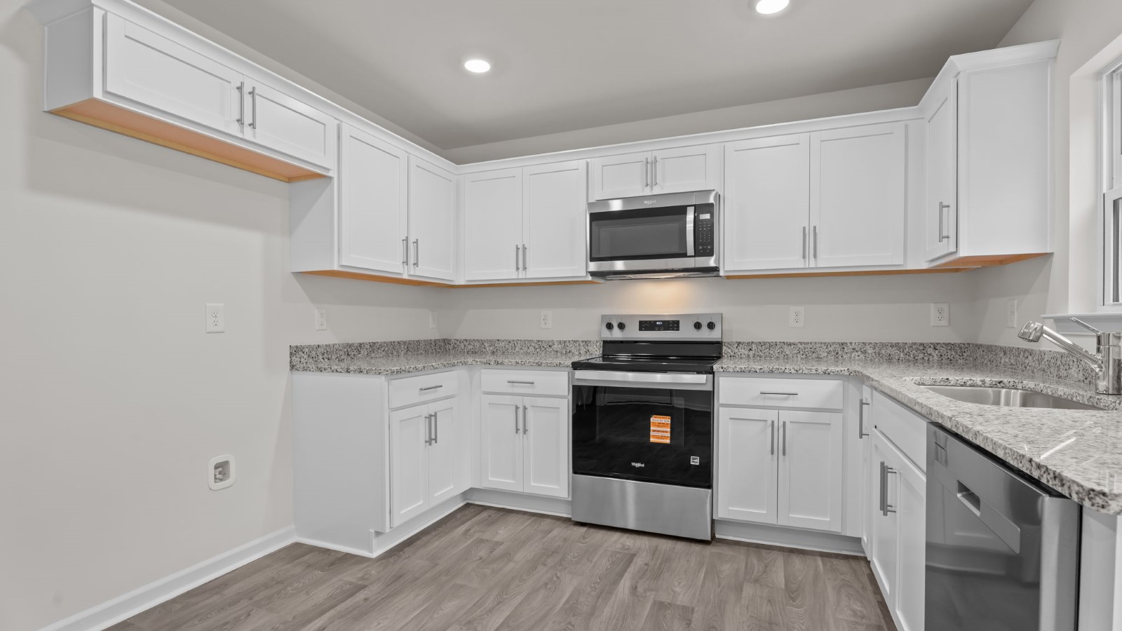 kitchen area with white cabinets