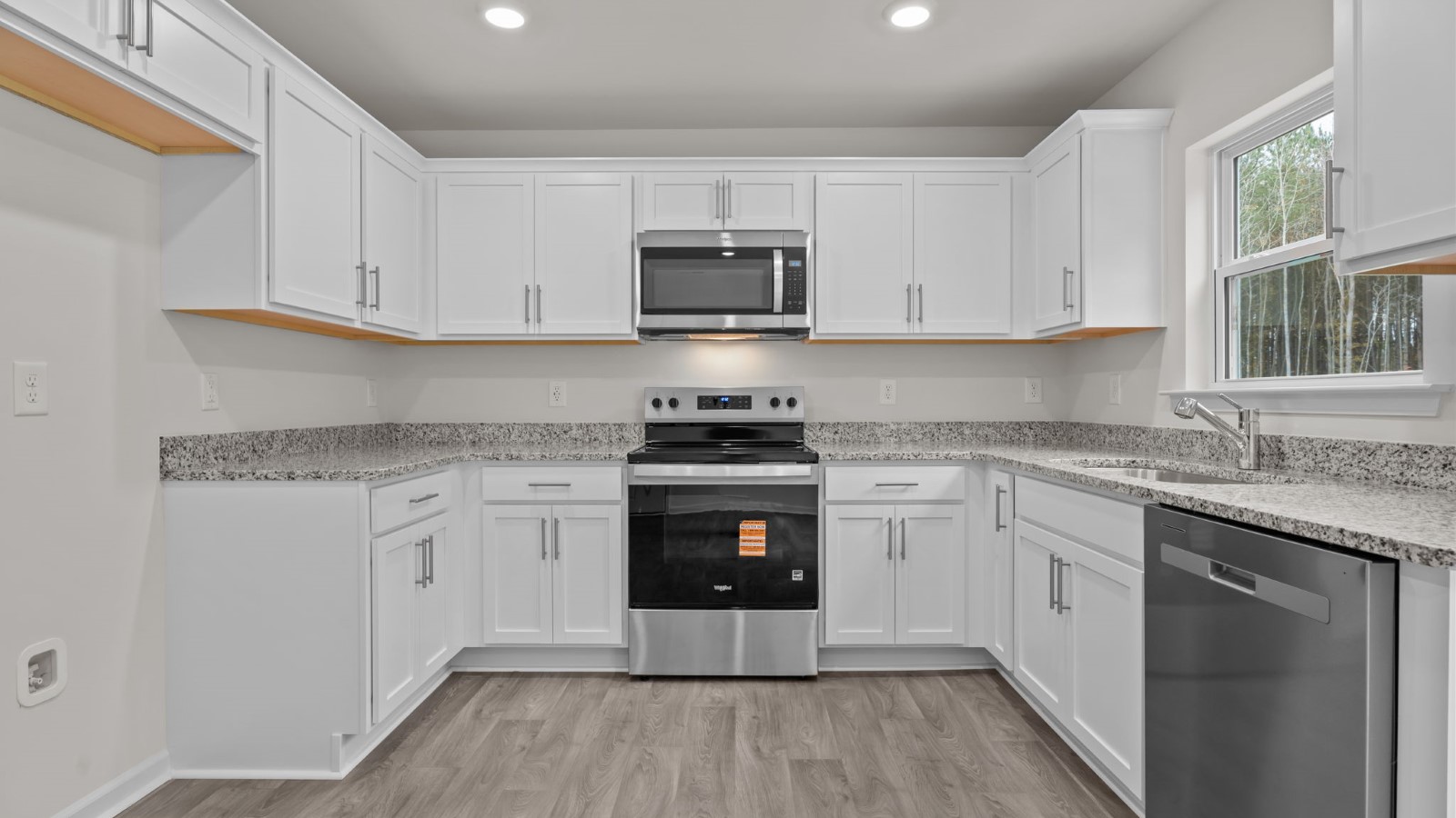 kitchen area with white cabinets and stainless steel appliances