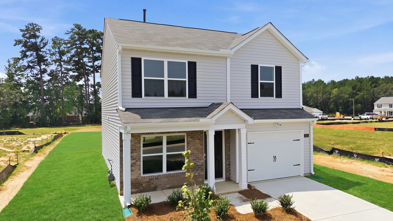 side view of two story family residence with two car garage