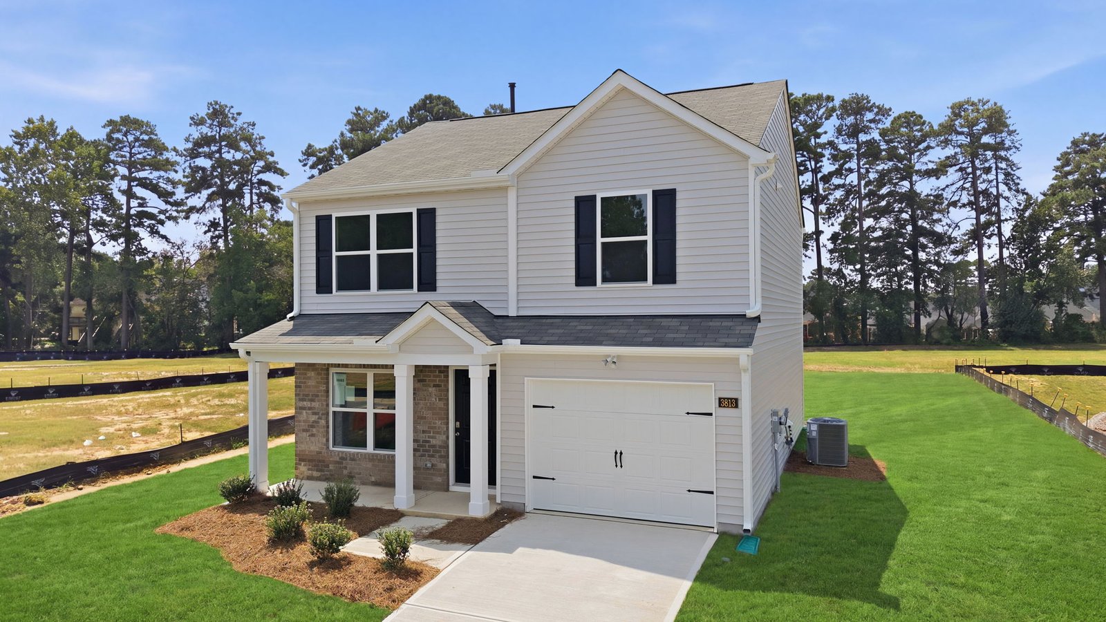 view of lot and driveway on two story home with driveway