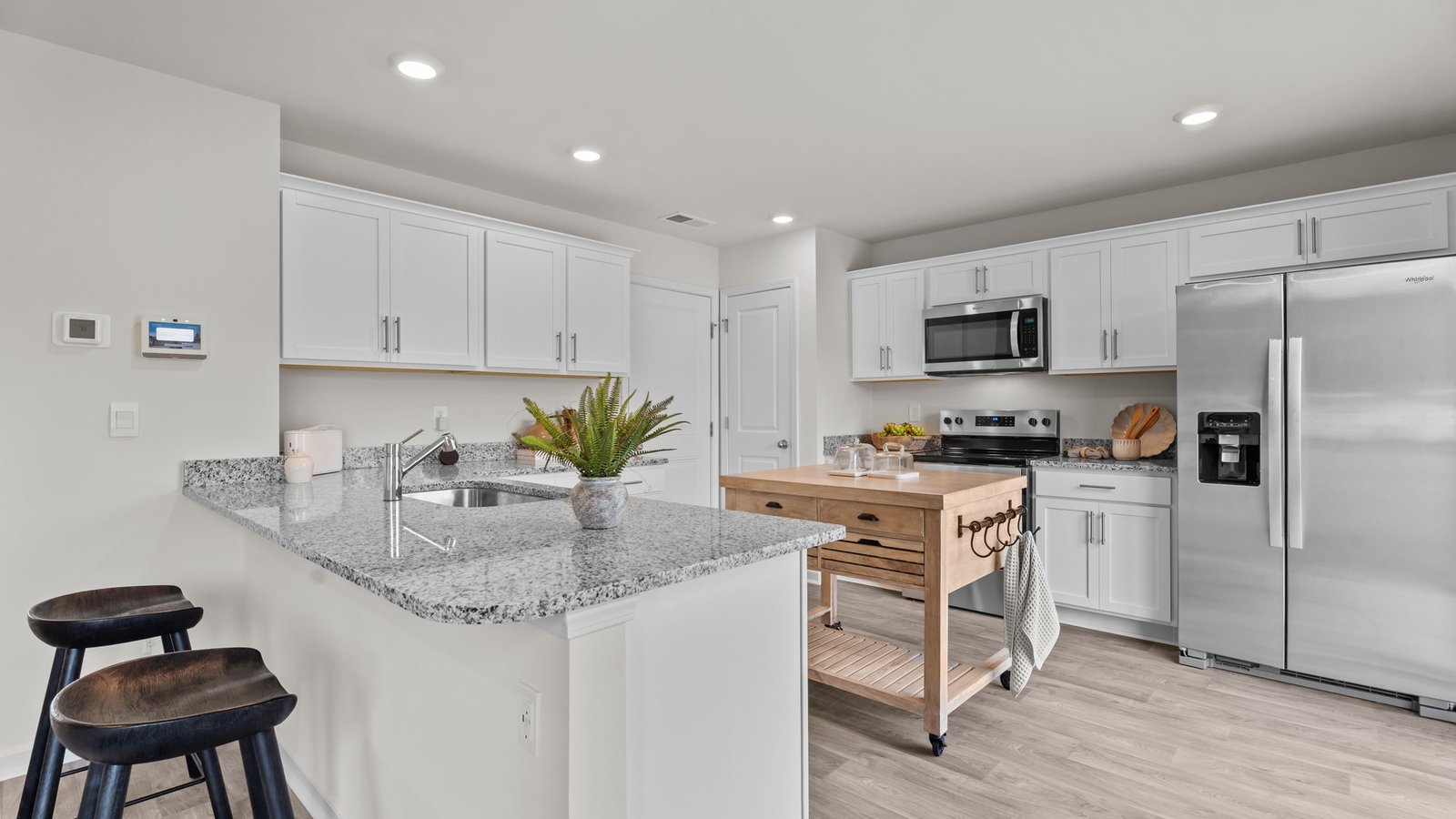 Kitchen area with island and stainless steel appliances