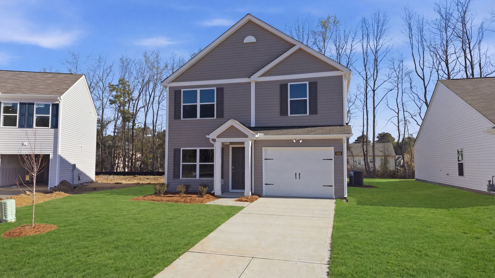 Two story brown house with garage