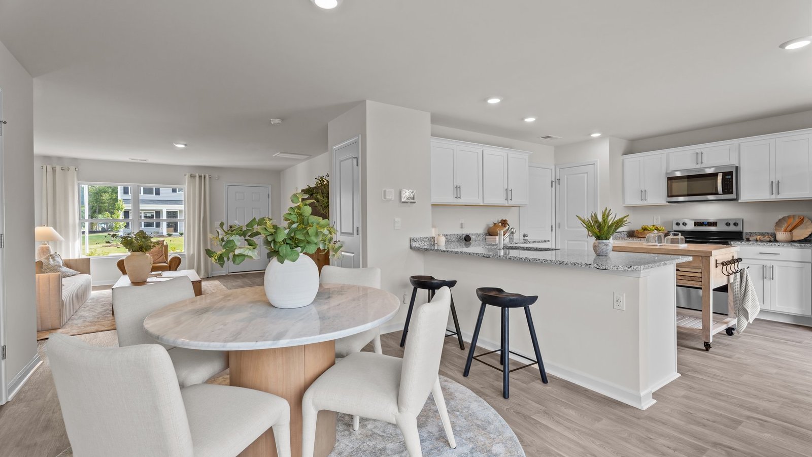 Dining area with kitchen view. Kitchen island and stainless steel appliances