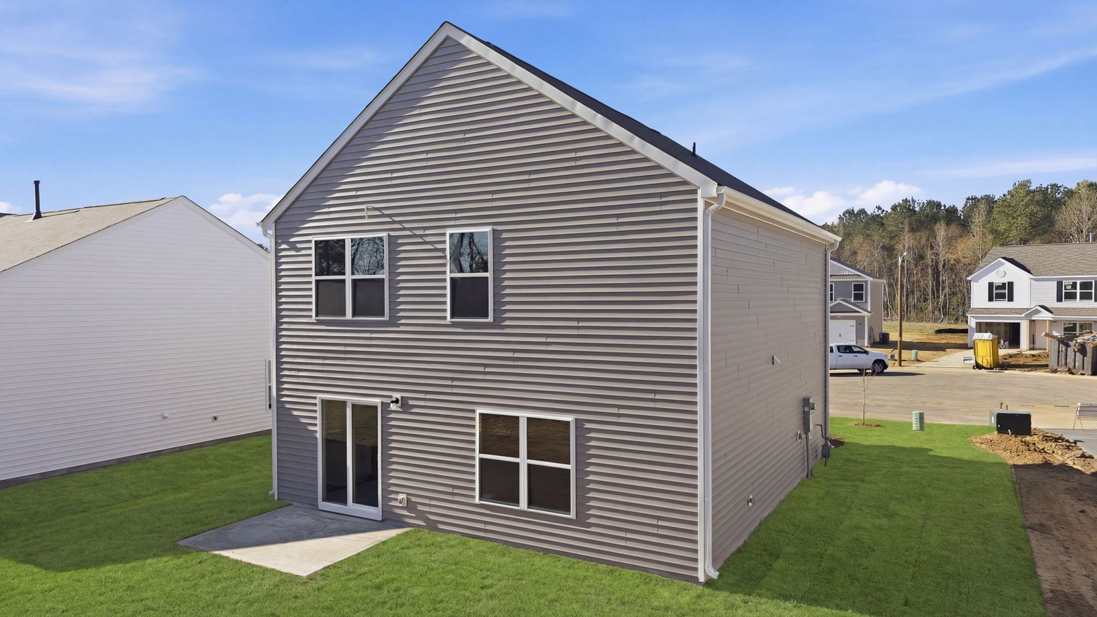 Rear image of back yard and back of two story home