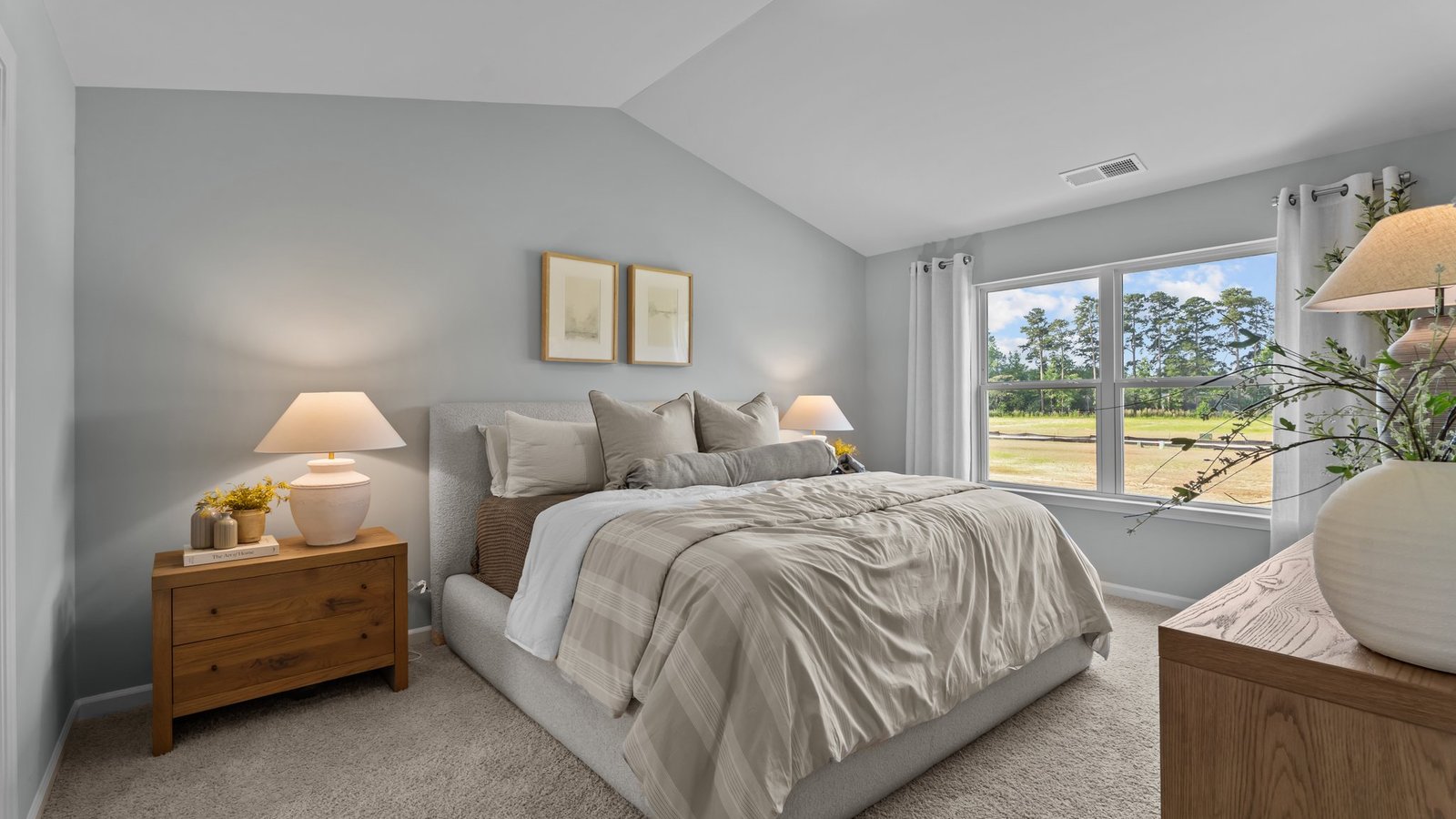Primary bedroom with high ceilings and large windows