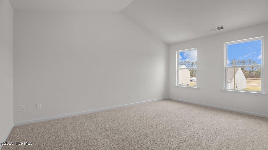 Primary bedroom with carpet flooring