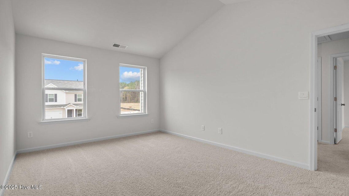 Primary bedroom with carpet flooring