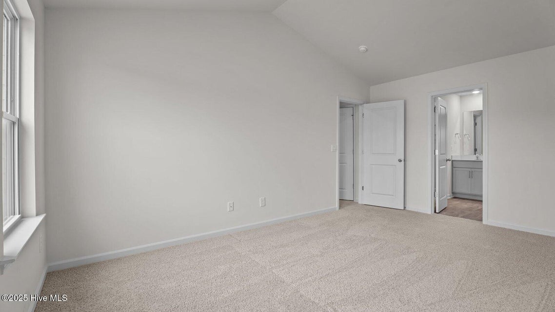 Primary bedroom with carpet flooring