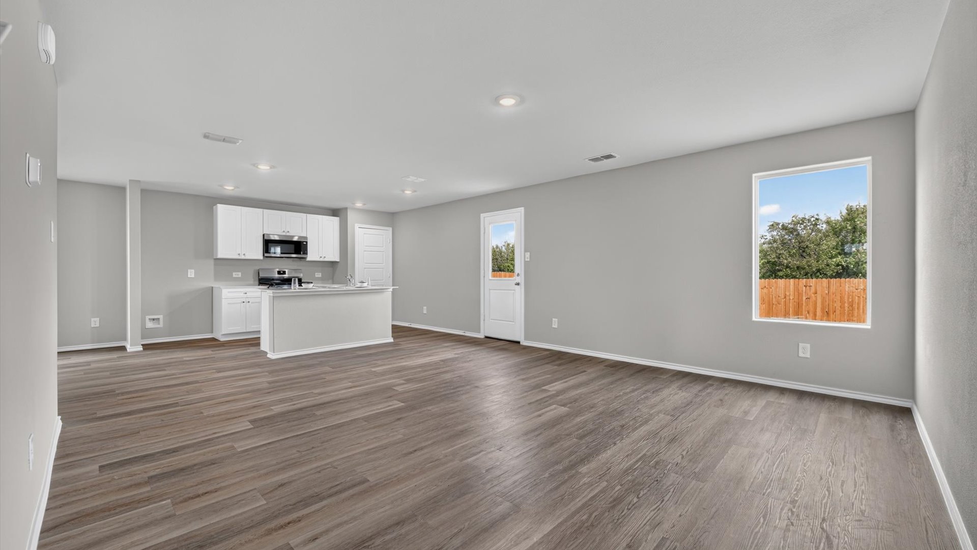 Open kitchen, dining, and living