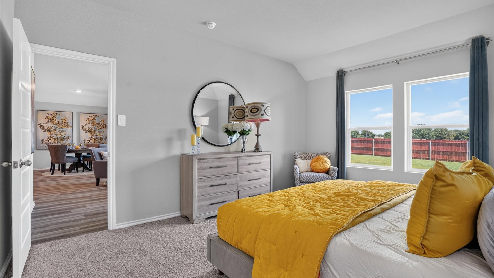 Bed 1 with plush carpet floors connecting to living area and heart of the home