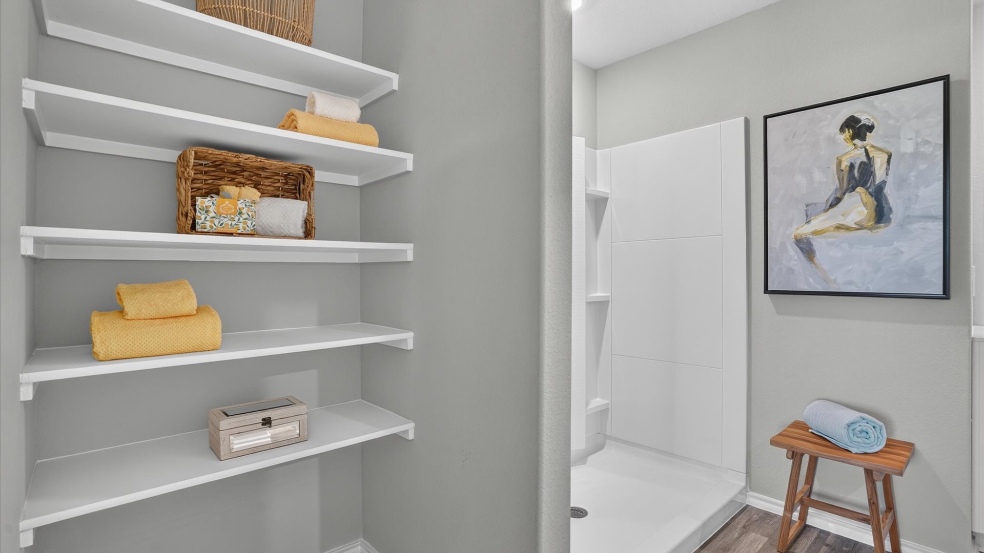 Primary bathroom with built-in storage shelves for linens