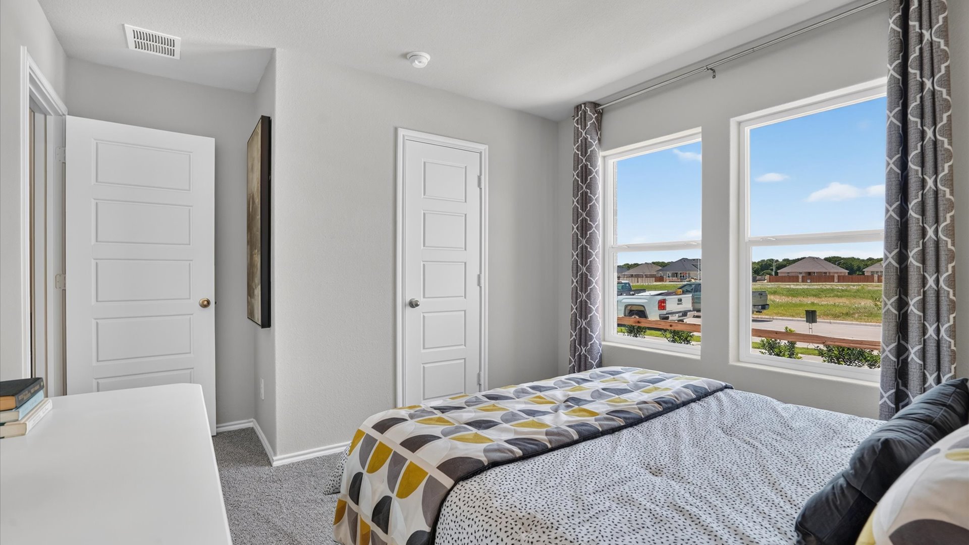 Bed 2 with plush carpet floors and front windows
