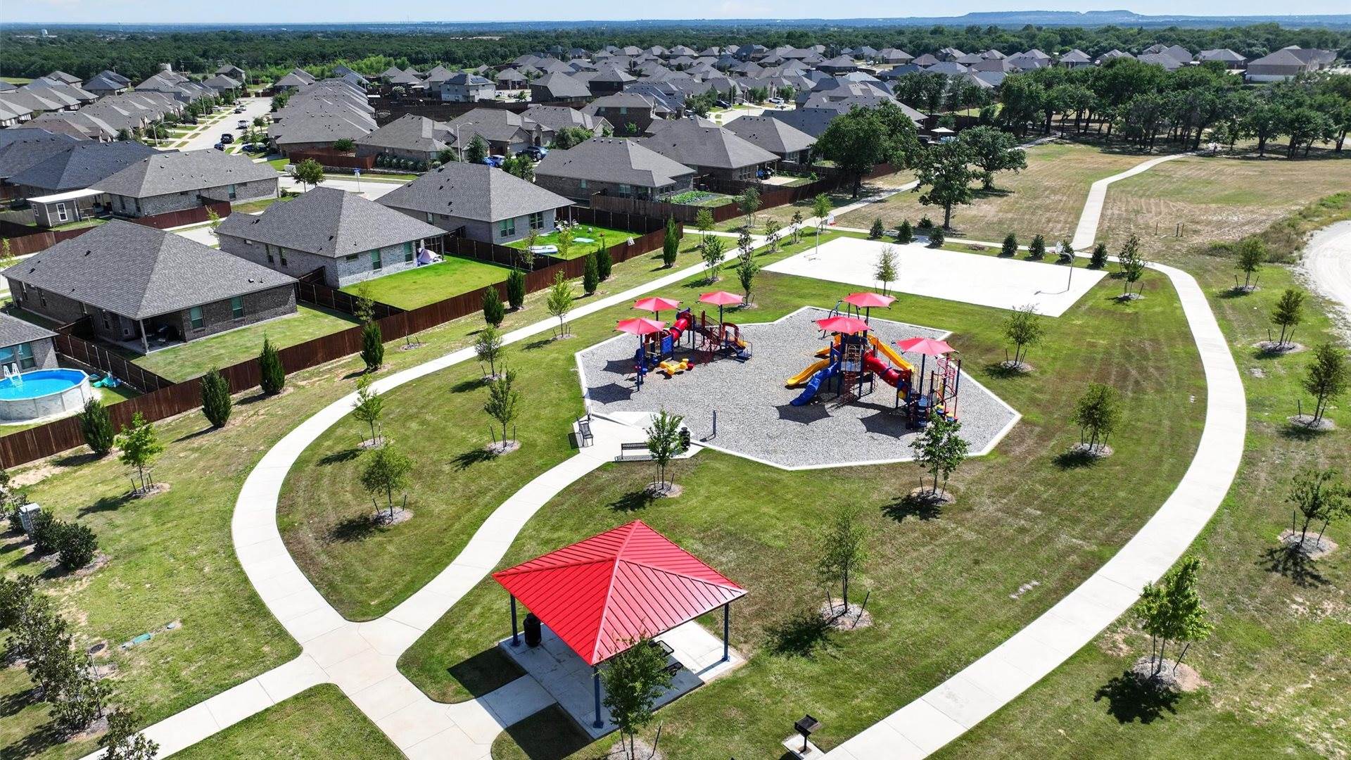Saratoga community playground with walking path and sports court