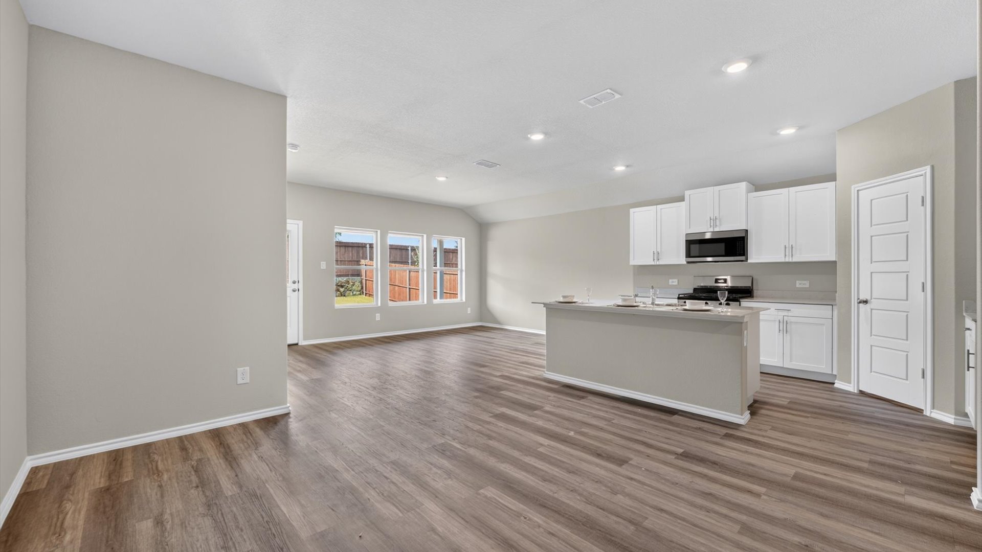 Open concept kitchen, dining, and living