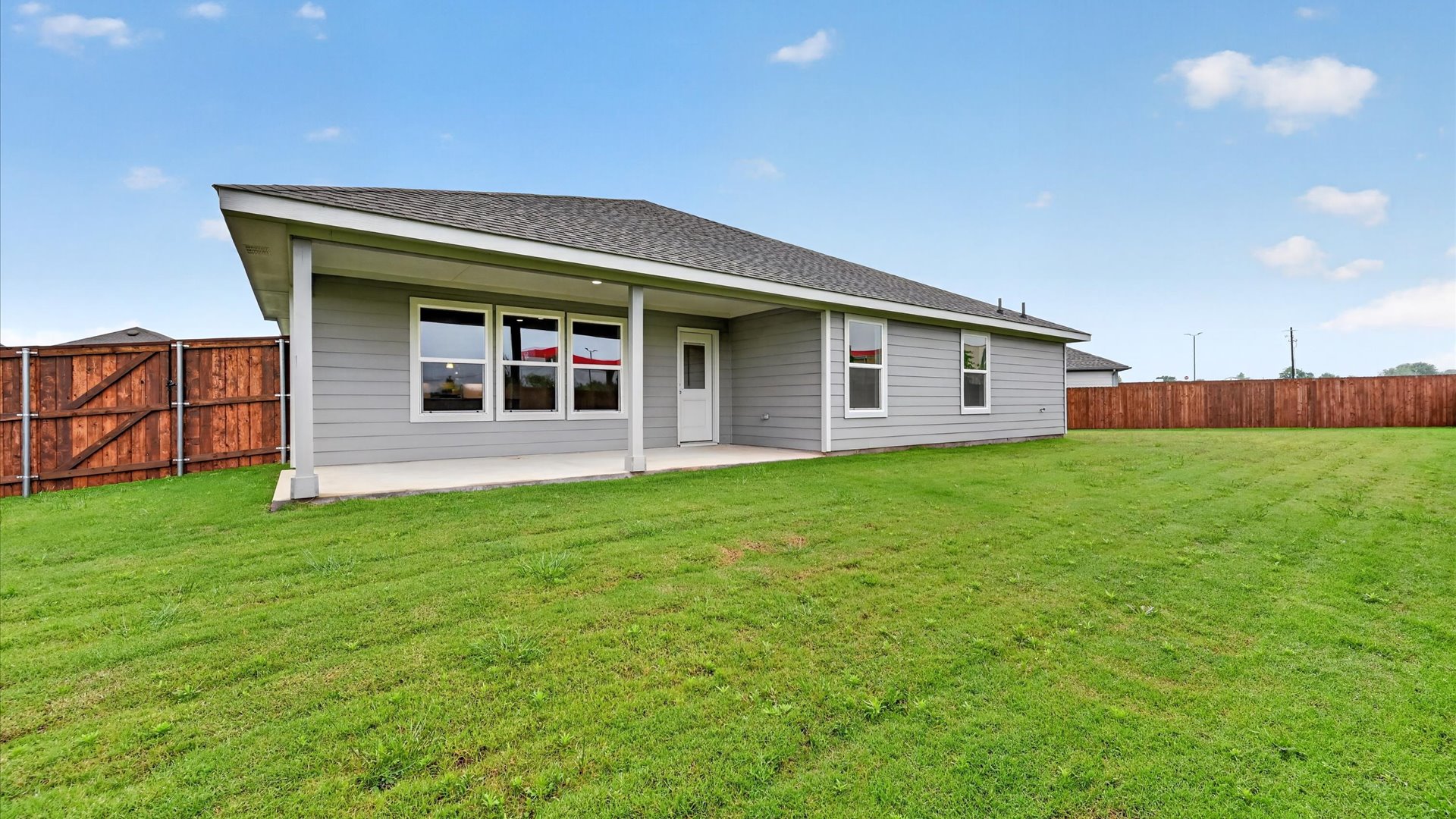 Covered back patio and spacious backyard