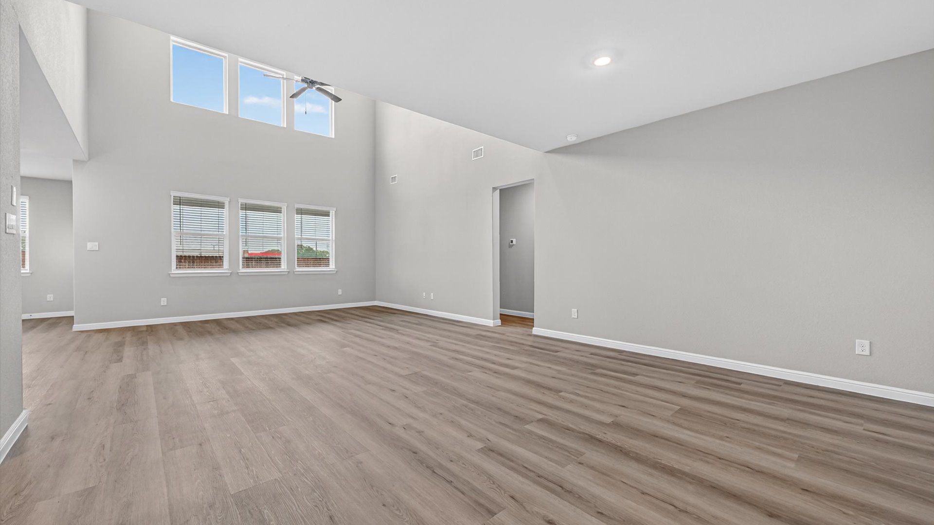 Open living and family room space with tall vaulted ceilings