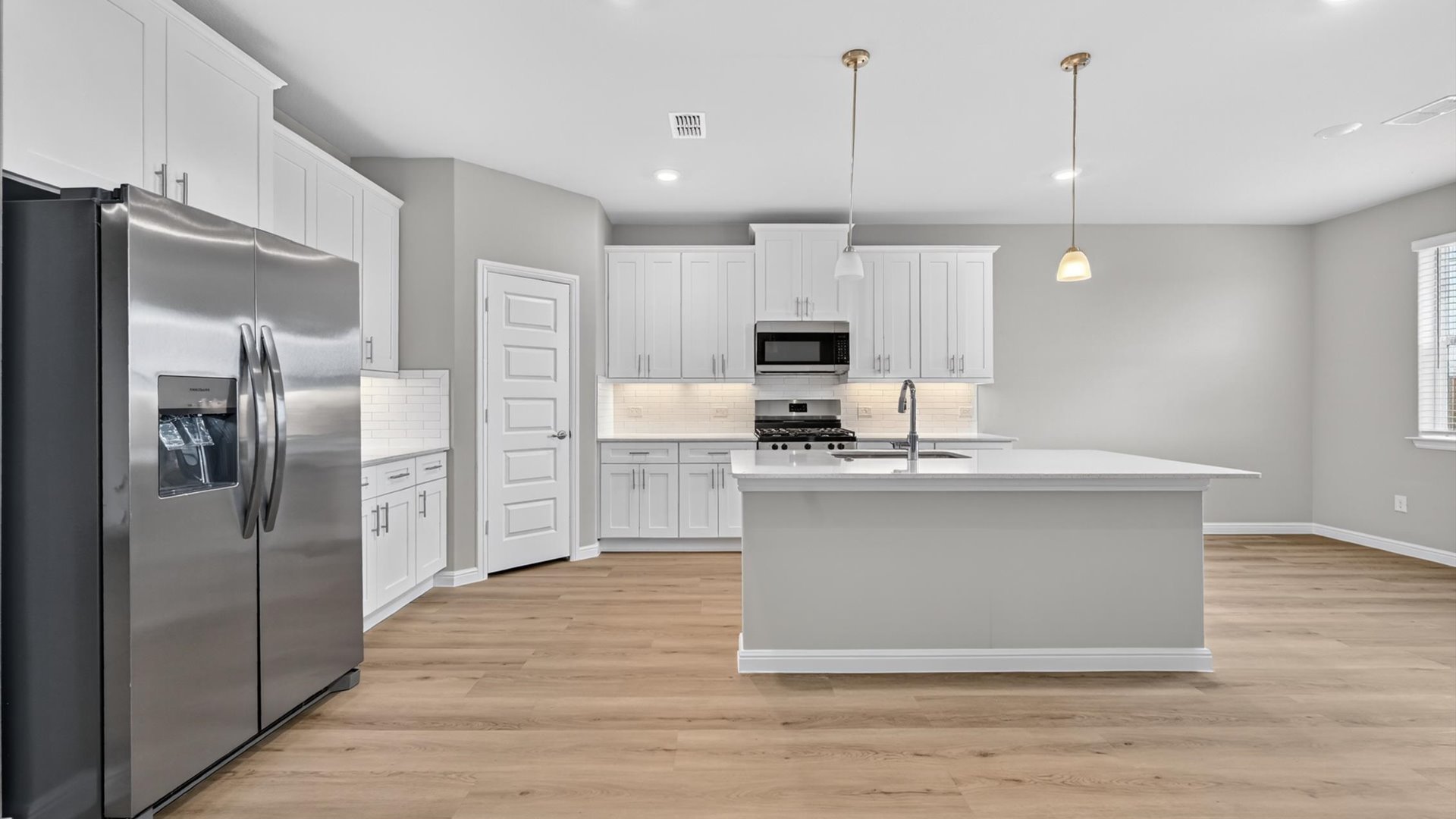 Kitchen overlooking living and dining space