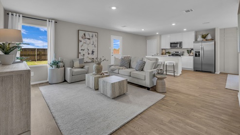 Living room opening to the kitchen and dining room.