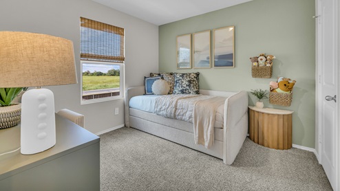 Secondary bedroom with carpeting and one window.