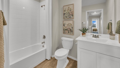 Hall bathroom with sink, toilet, and tub.