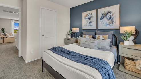 Secondary bedroom with carpeting.