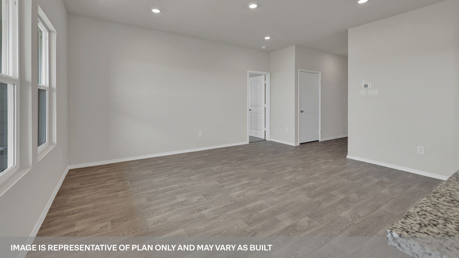 Living room with vinyl flooring and entry hallway.