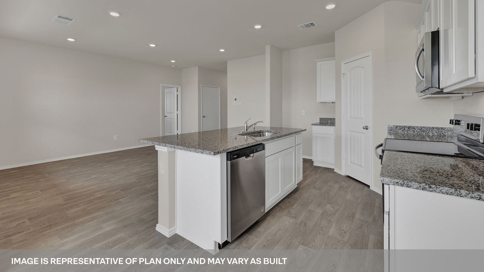 Kitchen with kitchen island and granite countertops.